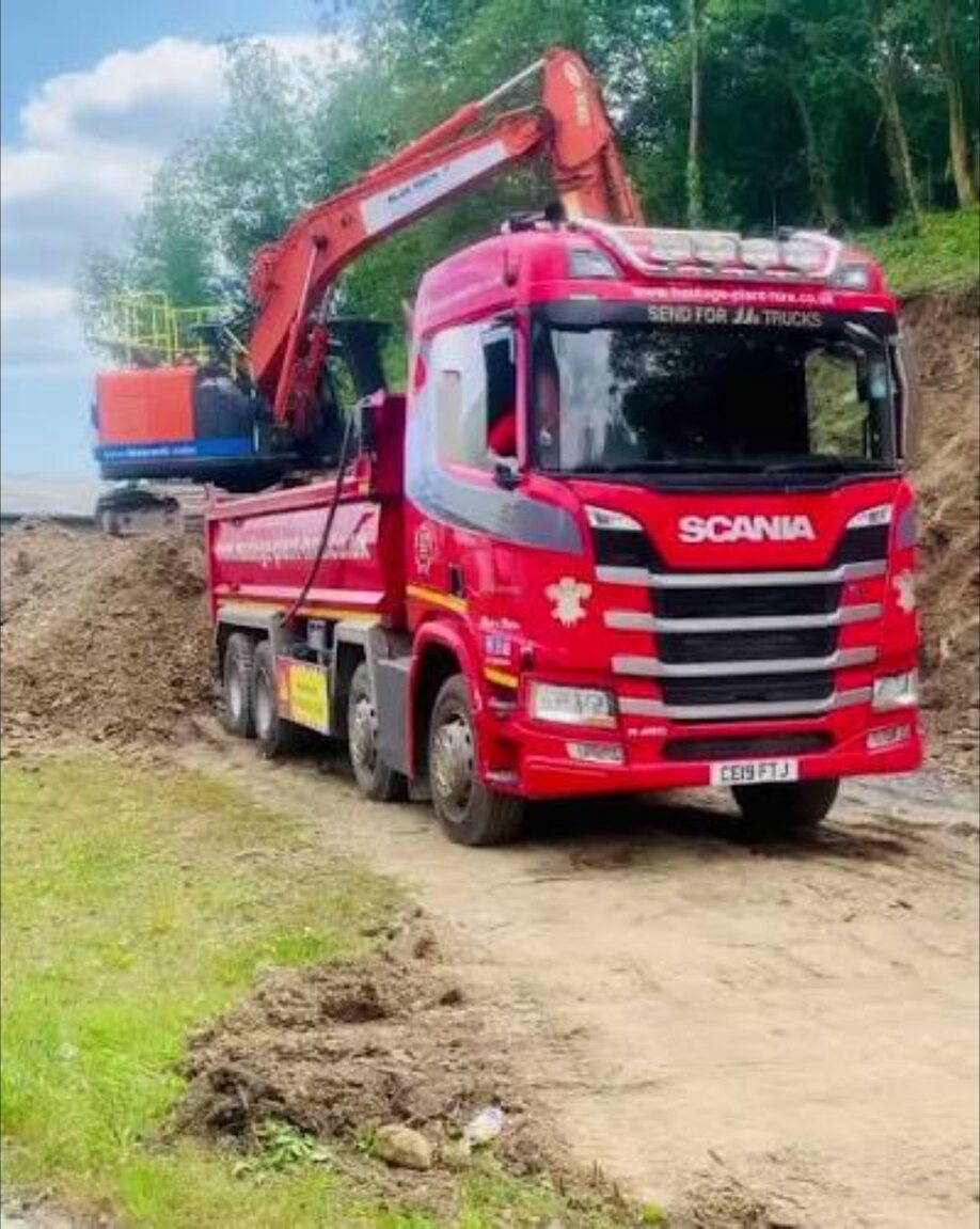 Grab lorry supporting muck away work on an access road